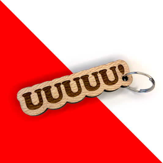 Houten sleutelhanger “UUUUU!” (Utrecht U-symbool), lokaal stadshout, speels design.
